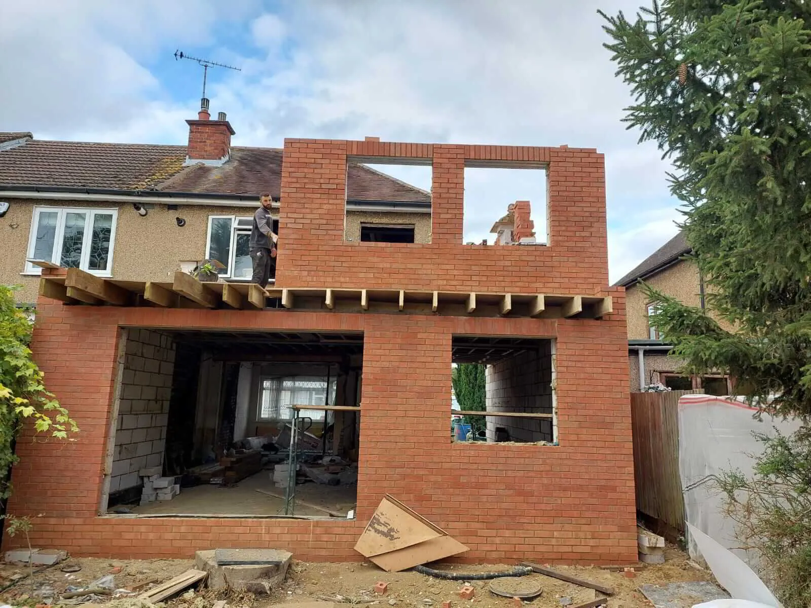 Bricklayer building a house extension wall in London
